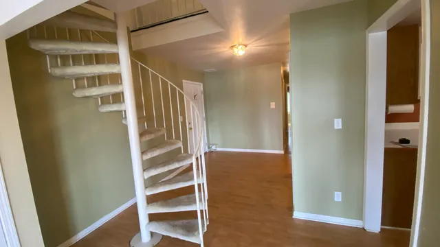a view of an empty room and stairs