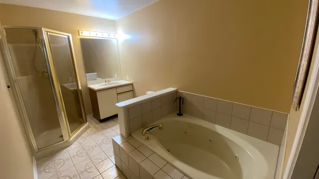 a bathroom with a tub sink and toilet