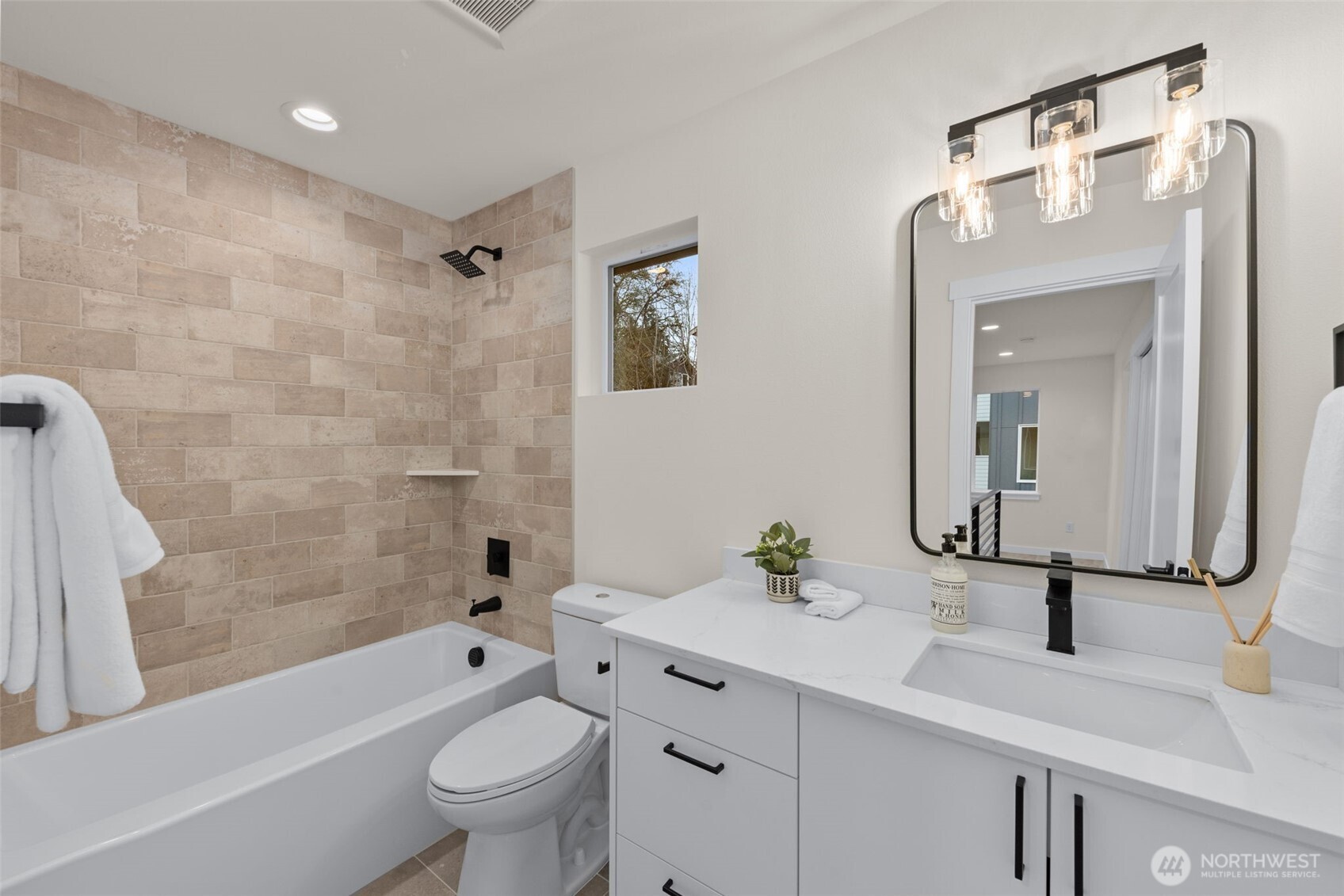 1109 26th Avenue South Seattle, WA 98144 - Photo 13 of 16 a bathroom with a sink a toilet and a large mirror