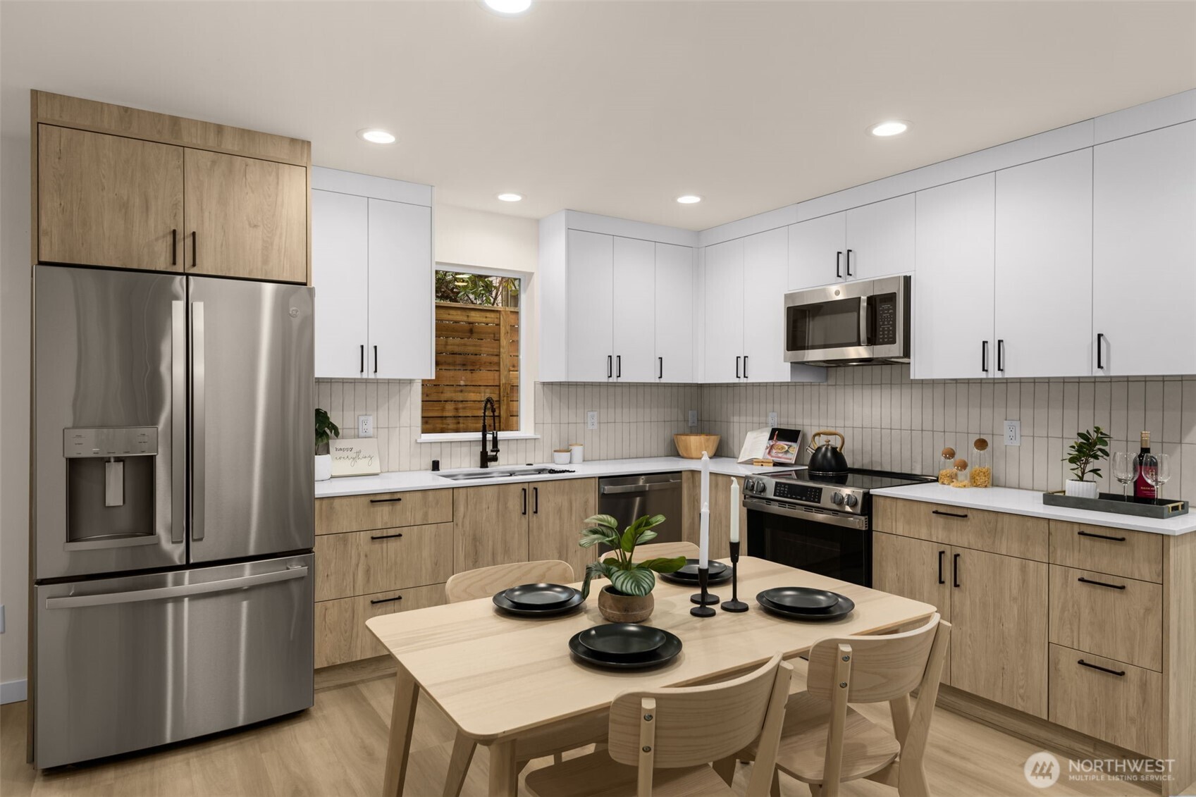 1109 26th Avenue South Seattle, WA 98144 - Photo 7 of 16 a kitchen with a sink a refrigerator and chairs