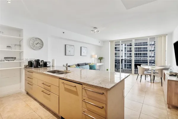 a open kitchen with cabinets and wooden floor