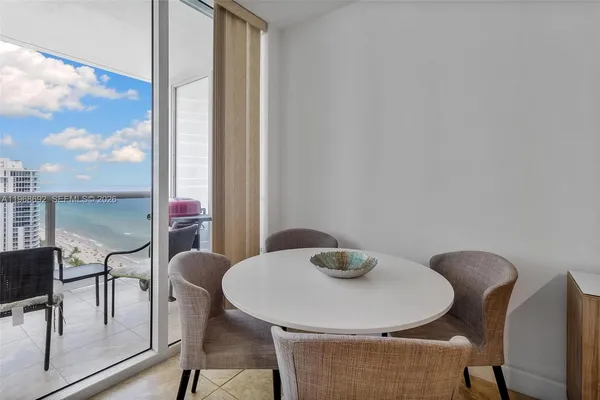 a view of a dining room with furniture and wooden floor