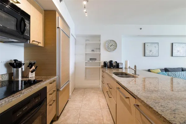 a large kitchen with stainless steel appliances granite countertop a sink and dishwasher stove