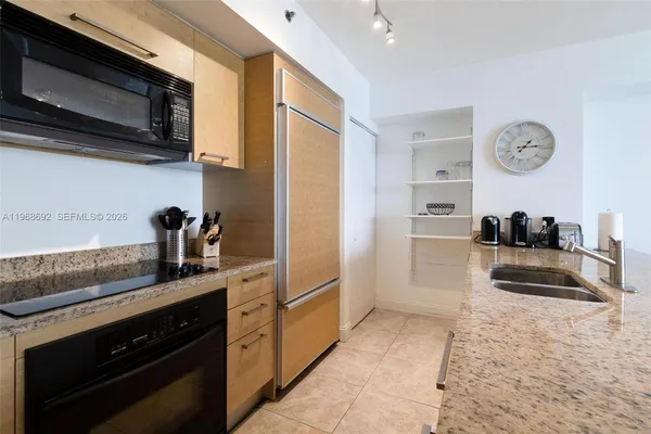 a kitchen with stainless steel appliances granite countertop a stove and a microwave