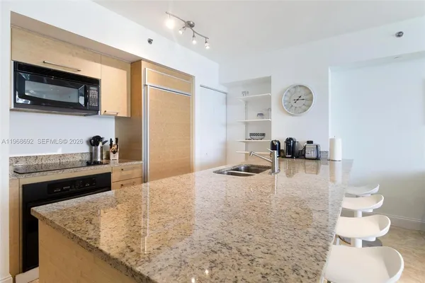 a kitchen with a sink a stove and a microwave