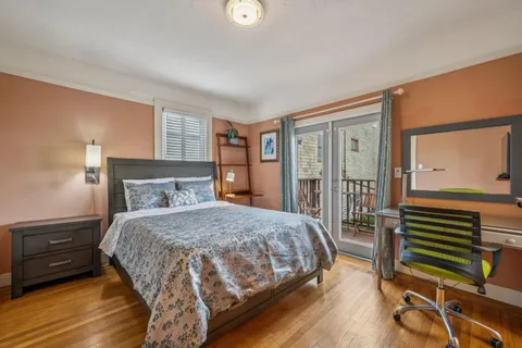 a bedroom with a bed a table and chair