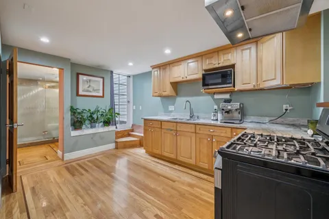 a kitchen with stainless steel appliances a stove microwave and cabinets