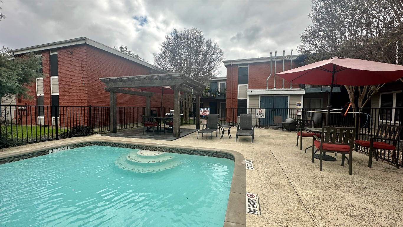 5426 Menchaca Road, Unit 203 Austin, TX 78745 - Photo 8 of 9 Community pool featuring a patio and a pergola