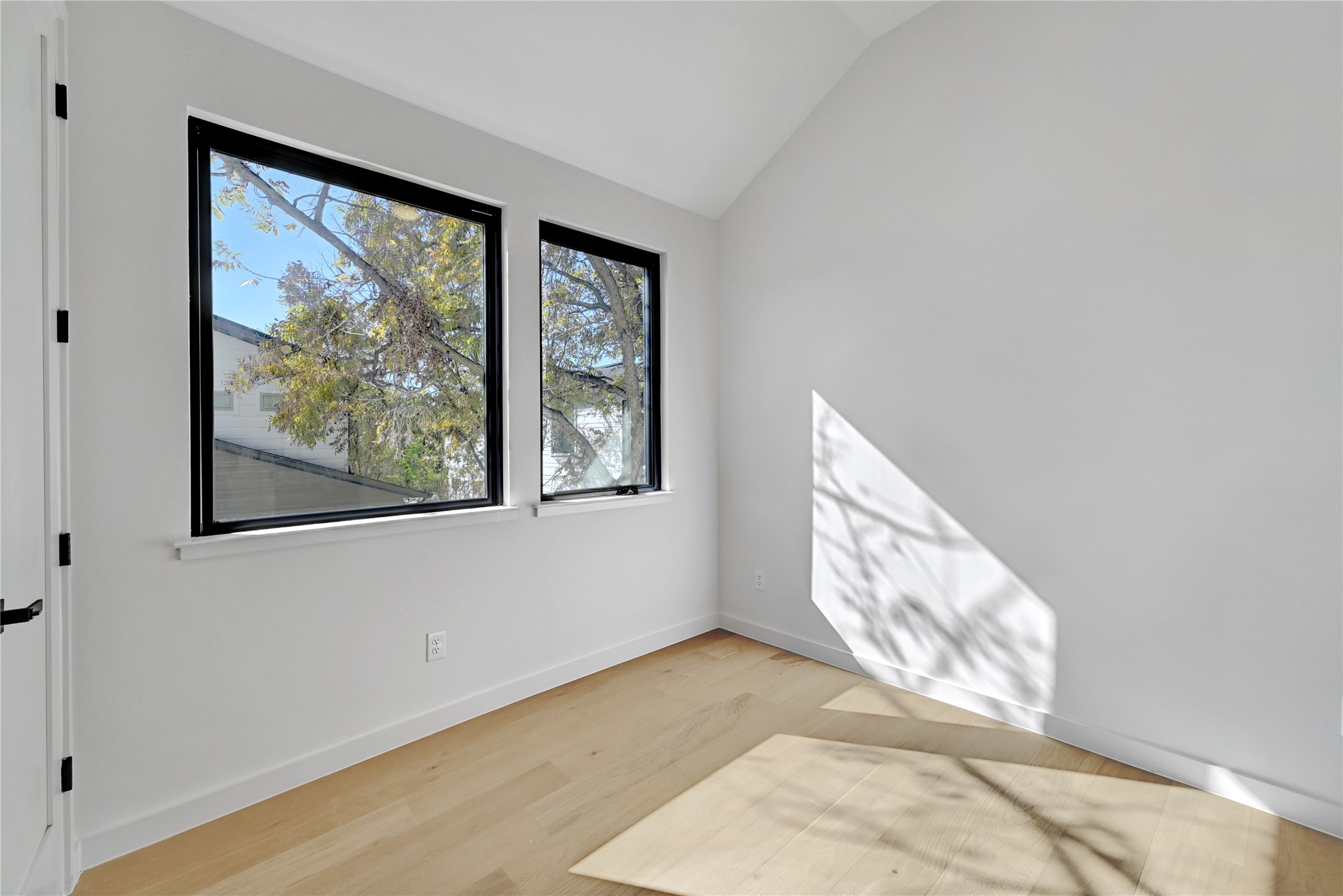 2717 Lyons Road, Unit 2 Austin, TX 78702 - Photo 18 of 20 a view of an empty room with wooden floor and a window