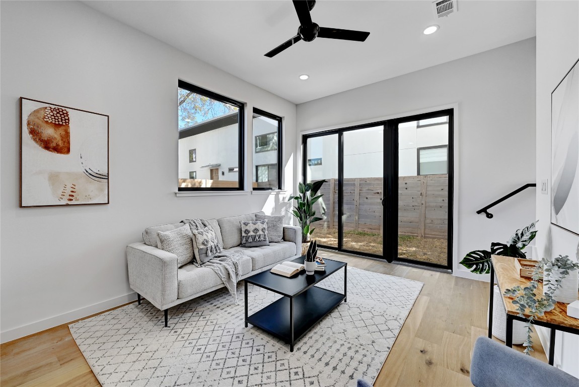 2717 Lyons Road, Unit 2 Austin, TX 78702 - Photo 6 of 20 a living room with furniture and floor to ceiling windows
