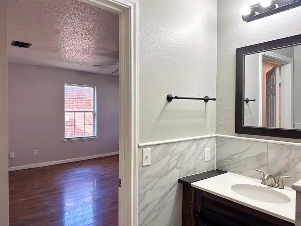 an empty room with wooden floor and window