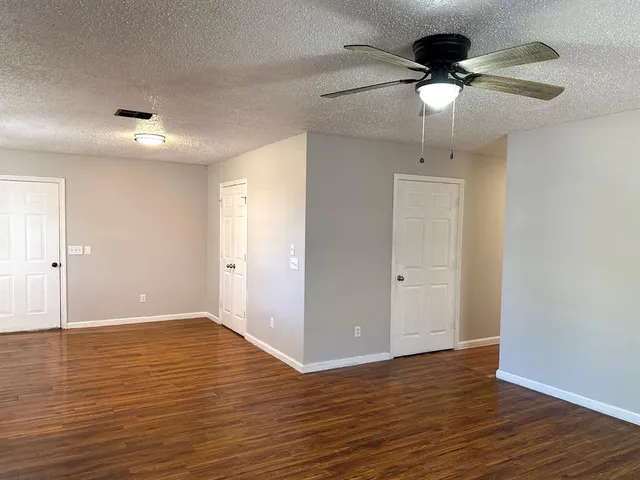 a view of a kitchen with a dishwasher cabinets and wooden floor