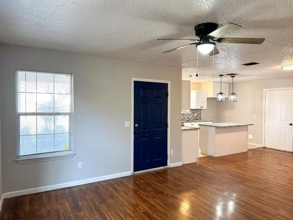 a kitchen with a sink cabinets and wooden floor