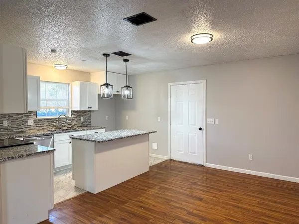 a view of a bedroom with wooden floor and closet