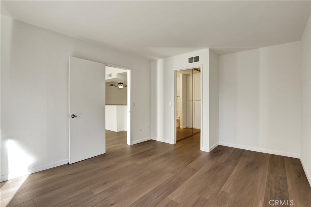 3000 Associated Road, Unit 60 Fullerton, CA 92835 - Photo 18 of 56 a view of an empty room with wooden floor and closet