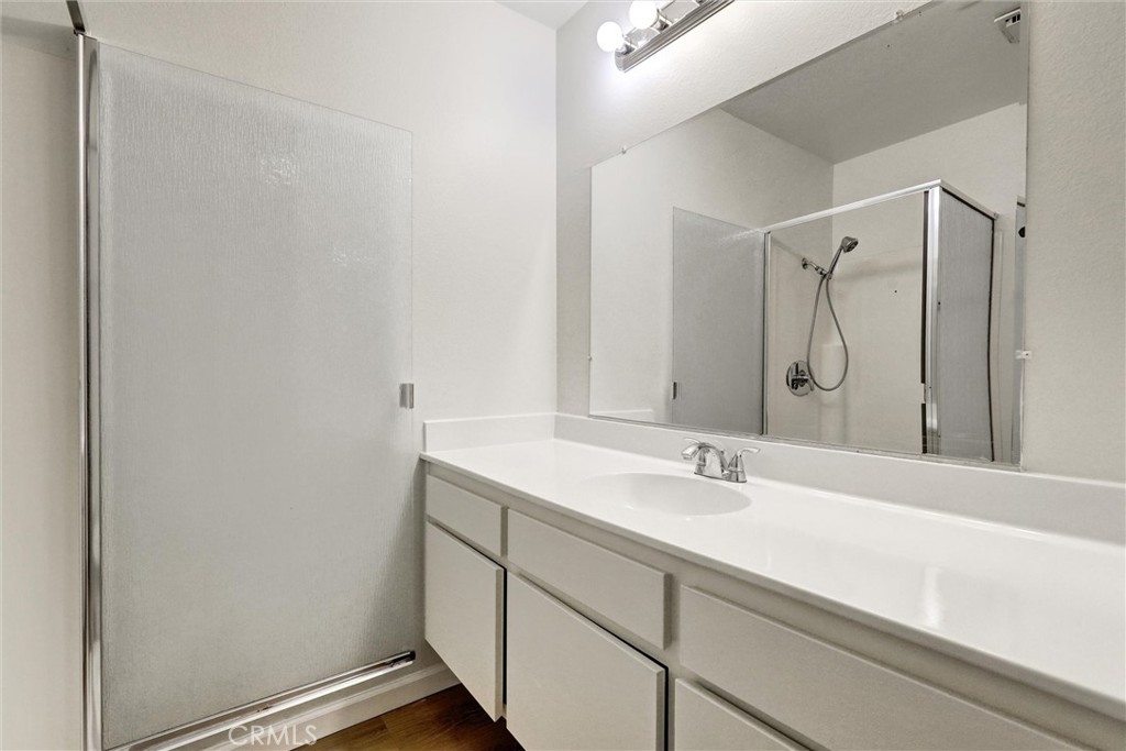 3000 Associated Road, Unit 60 Fullerton, CA 92835 - Photo 19 of 51 a bathroom with a sink and a mirror