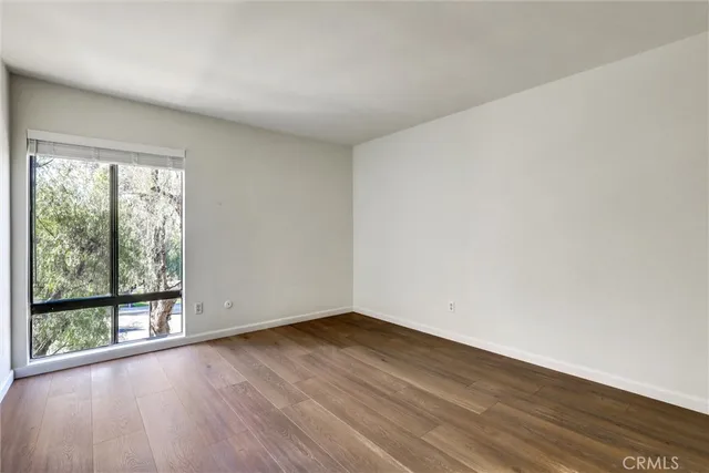an empty room with wooden floor and closet