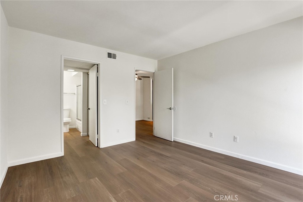 3000 Associated Road, Unit 60 Fullerton, CA 92835 - Photo 23 of 56 a view of an empty room with wooden floor and closet