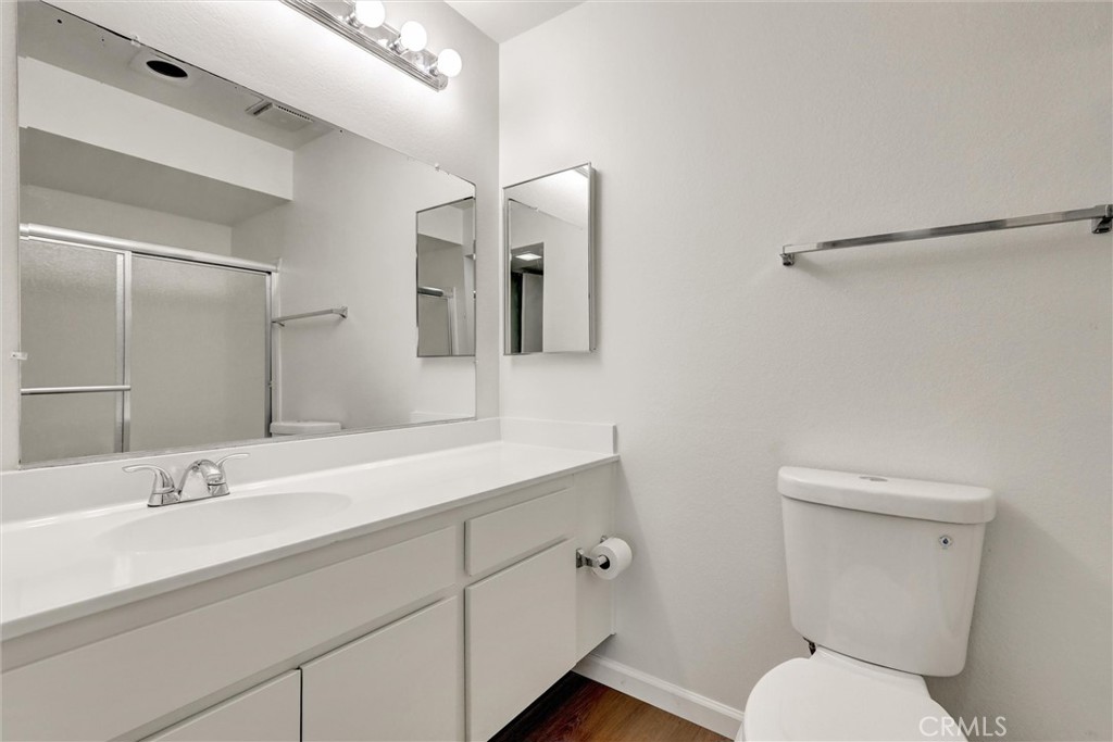 3000 Associated Road, Unit 60 Fullerton, CA 92835 - Photo 26 of 56 a bathroom with a toilet sink and mirror