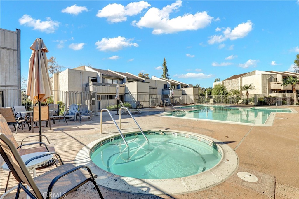 3000 Associated Road, Unit 60 Fullerton, CA 92835 - Photo 28 of 51 a swimming pool with outdoor seating and yard