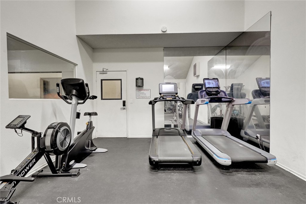 3000 Associated Road, Unit 60 Fullerton, CA 92835 - Photo 35 of 51 a room with gym equipment and large mirror
