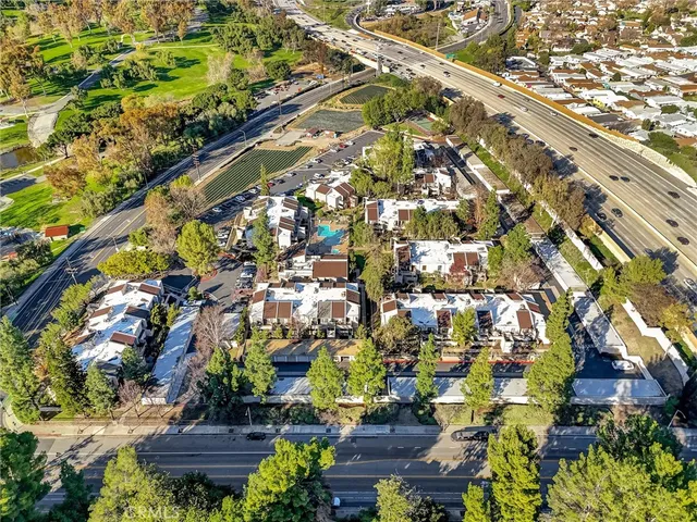 an aerial view of multiple houses with yard