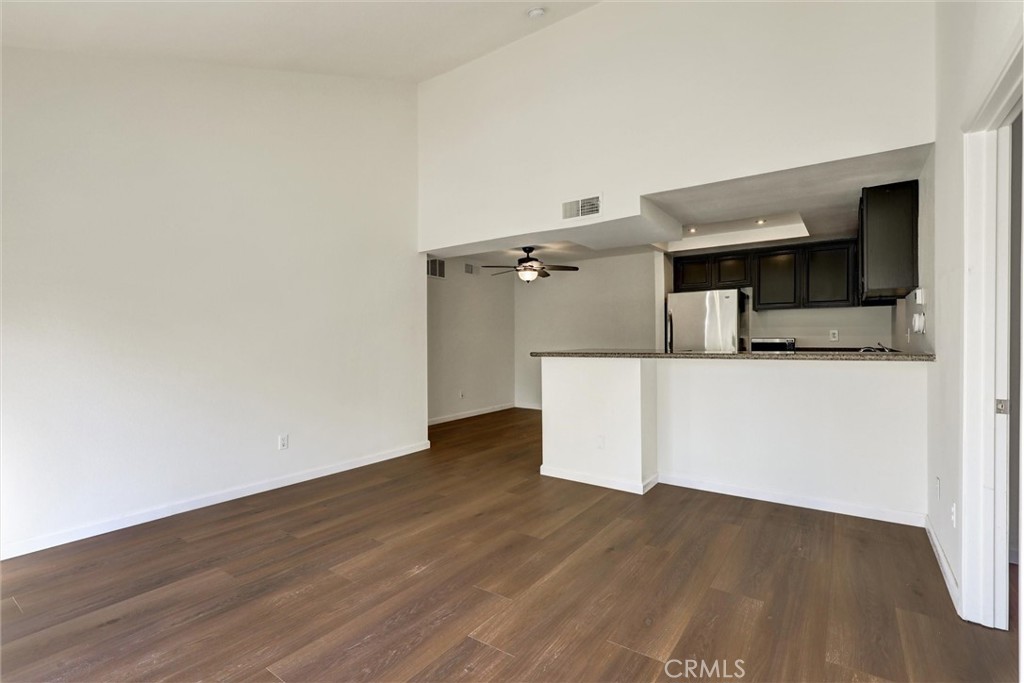 3000 Associated Road, Unit 60 Fullerton, CA 92835 - Photo 8 of 51 a view of a kitchen with wooden floor and a refrigerator