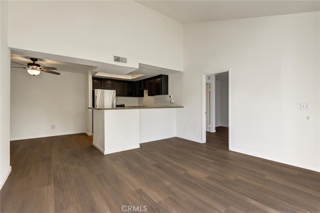 3000 Associated Road, Unit 60 Fullerton, CA 92835 - Photo 9 of 56 a view of a kitchen with a sink and wooden floor