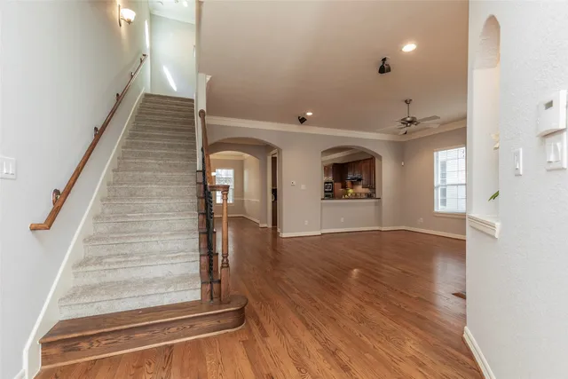 a view of entryway and hall with wooden floor