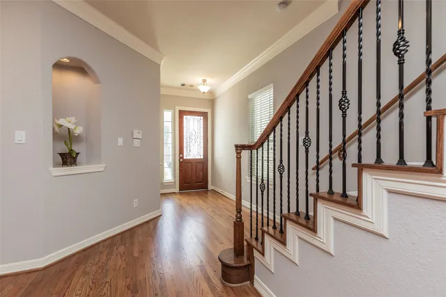a view of an entryway with wooden floor and stairs