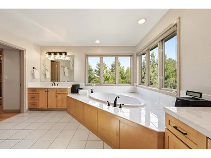 a kitchen with a sink window and cabinets