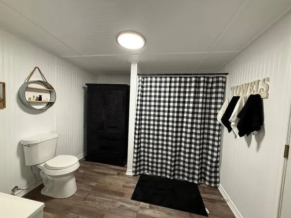 a bathroom with a toilet and a shower