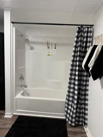 a bathroom with a bathtub and shower