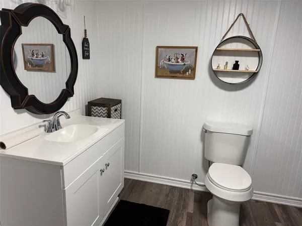 a bathroom with a toilet a sink and a mirror