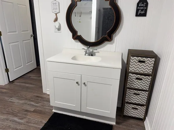 a bathroom with a sink a toilet and a mirror