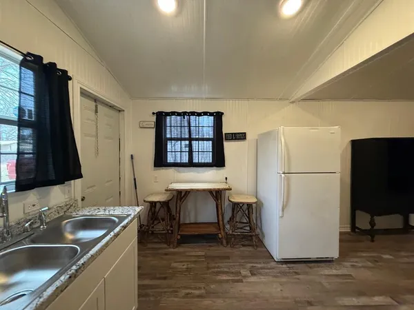a kitchen with a sink and a refrigerator