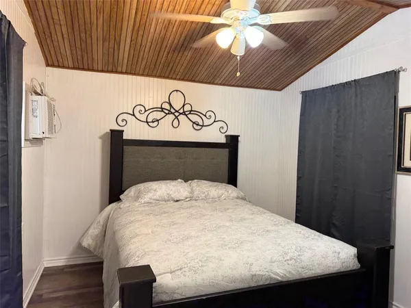a bed sitting in a bedroom next to a window