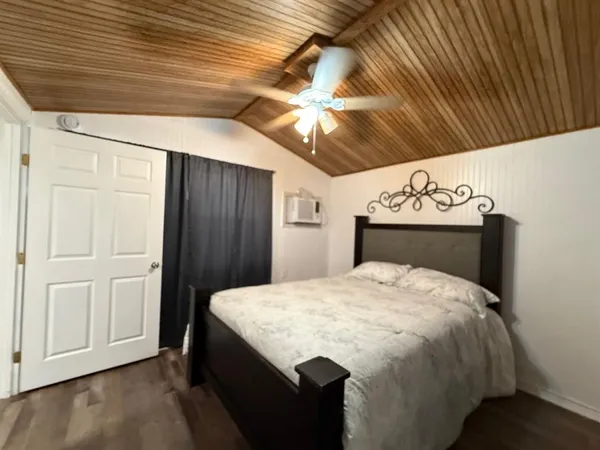 a bed sitting in a bedroom next to a window