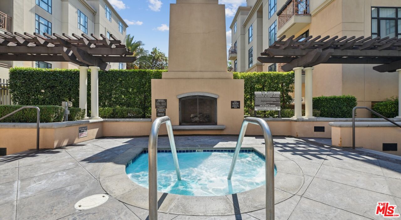 290 North Hudson Avenue, Unit 101W Pasadena, CA 91101 - Photo 12 of 21 a view of a patio with a table and chairs with wooden floor
