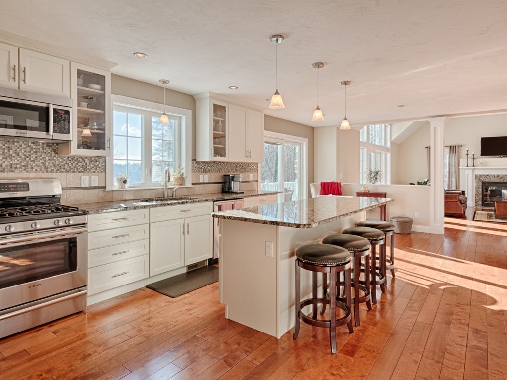 31 Harriman Road Merrimac, MA 01860 - Photo 6 of 30 a kitchen with stainless steel appliances a stove a sink dishwasher a refrigerator with white cabinets and wooden floor