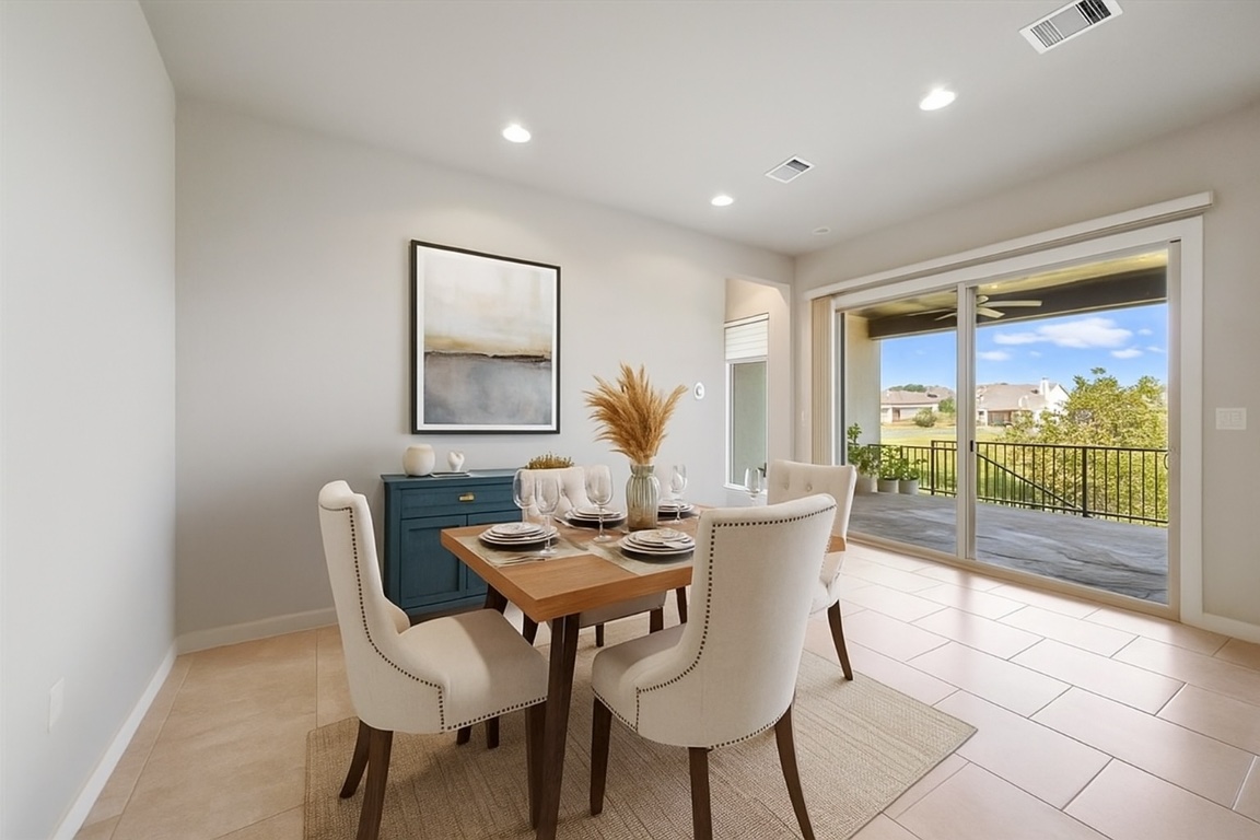 437 Pienza Drive Georgetown, TX 78628 - Photo 16 of 32 Dining room with views of greenspace and lake -virtually staged