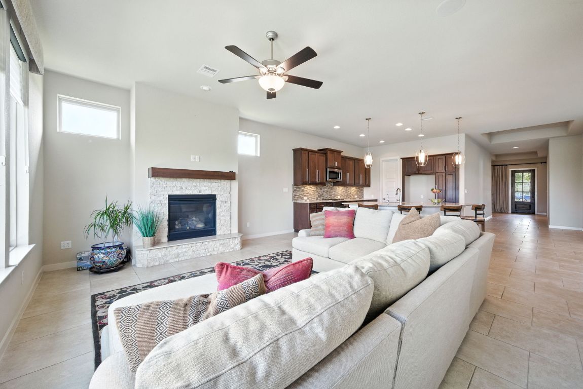 437 Pienza Drive Georgetown, TX 78628 - Photo 18 of 32 a living room with furniture kitchen and a fireplace