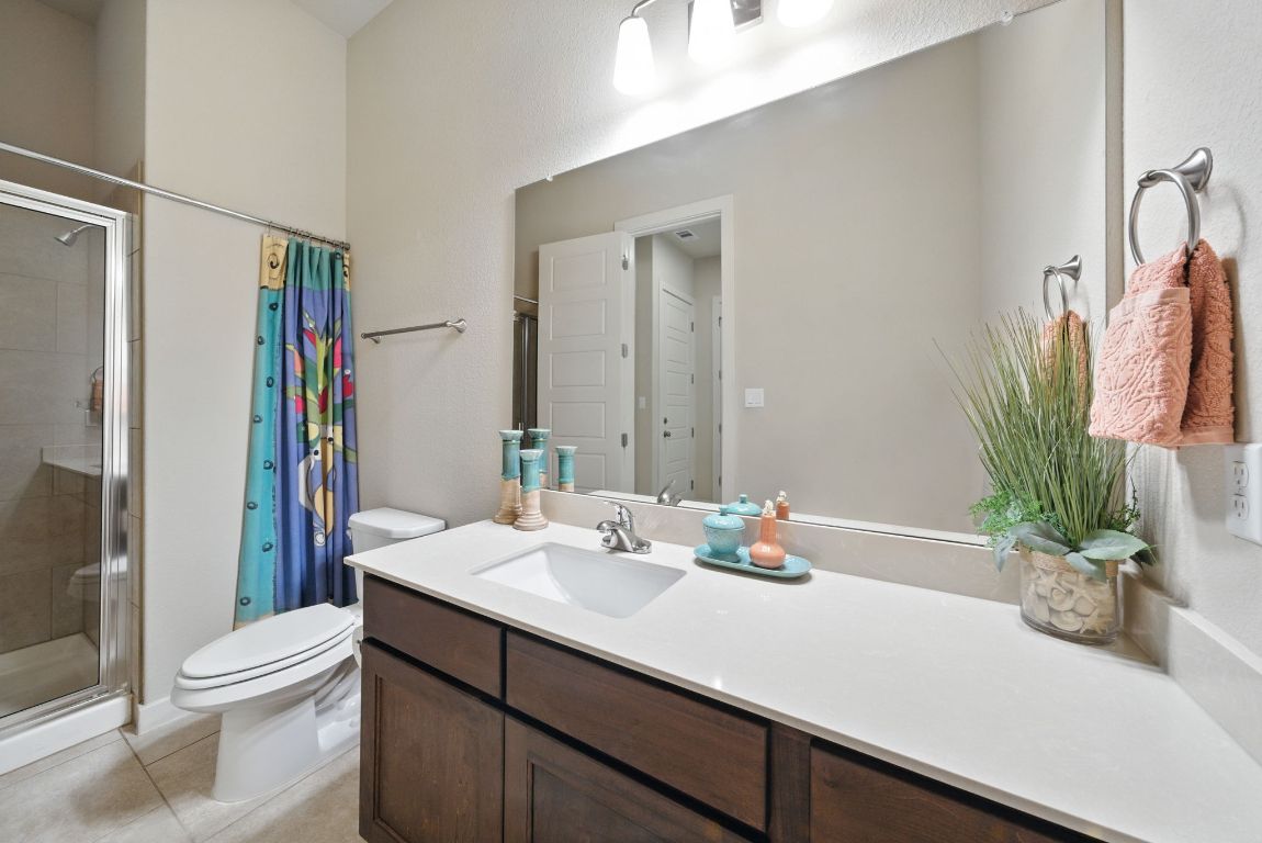 437 Pienza Drive Georgetown, TX 78628 - Photo 7 of 32 a bathroom with a sink a toilet and shower