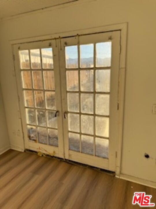 4908 Fort Tejon Road Palmdale, CA 93552 - Photo 16 of 21 an empty room with wooden floor and windows
