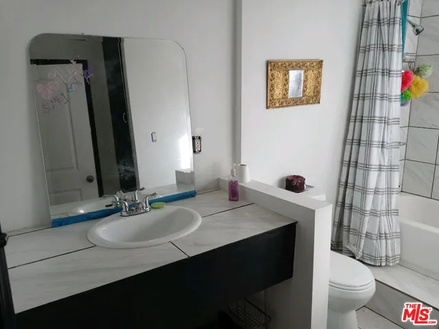 a view of wooden floor and window in a room