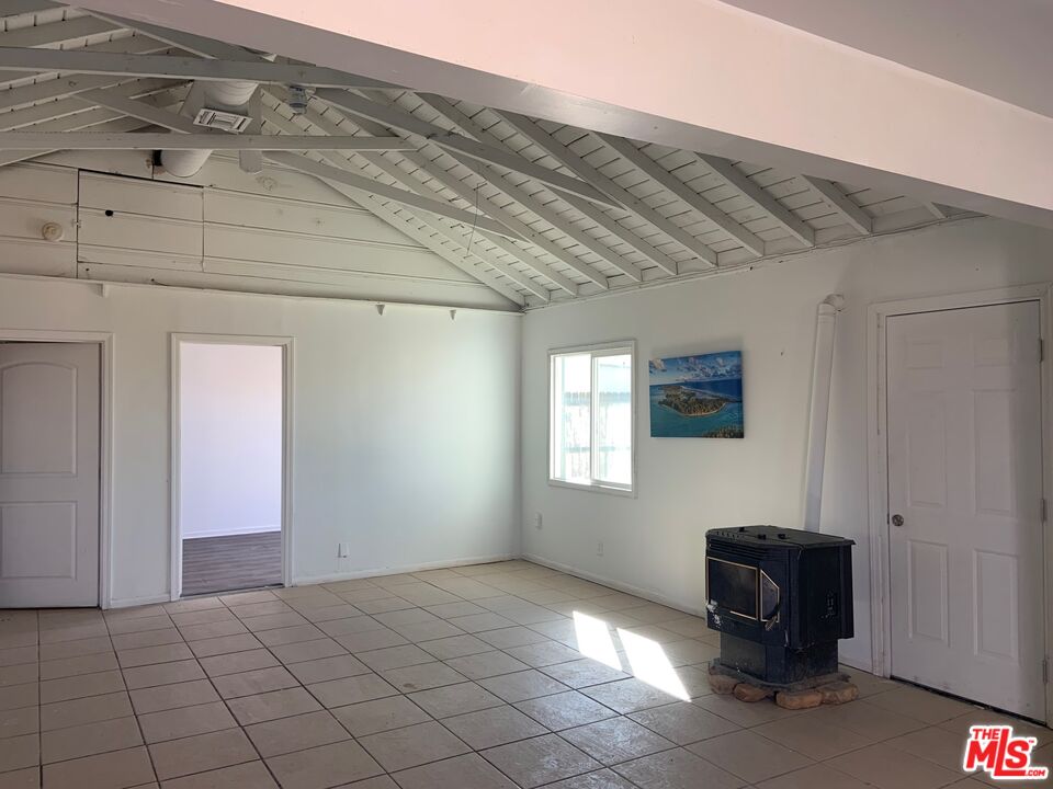 4908 Fort Tejon Road Palmdale, CA 93552 - Photo 4 of 21 a view of an empty room with a window