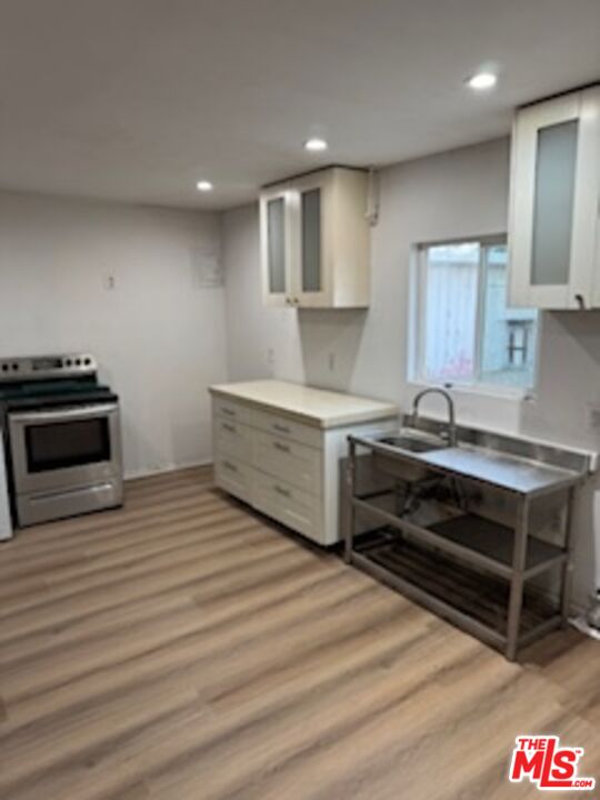 4908 Fort Tejon Road Palmdale, CA 93552 - Photo 6 of 21 a kitchen with stainless steel appliances a stove and cabinets