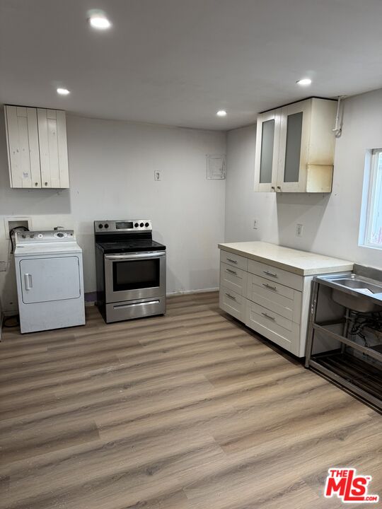 4908 Fort Tejon Road Palmdale, CA 93552 - Photo 8 of 21 a kitchen with stainless steel appliances a stove a sink and a refrigerator