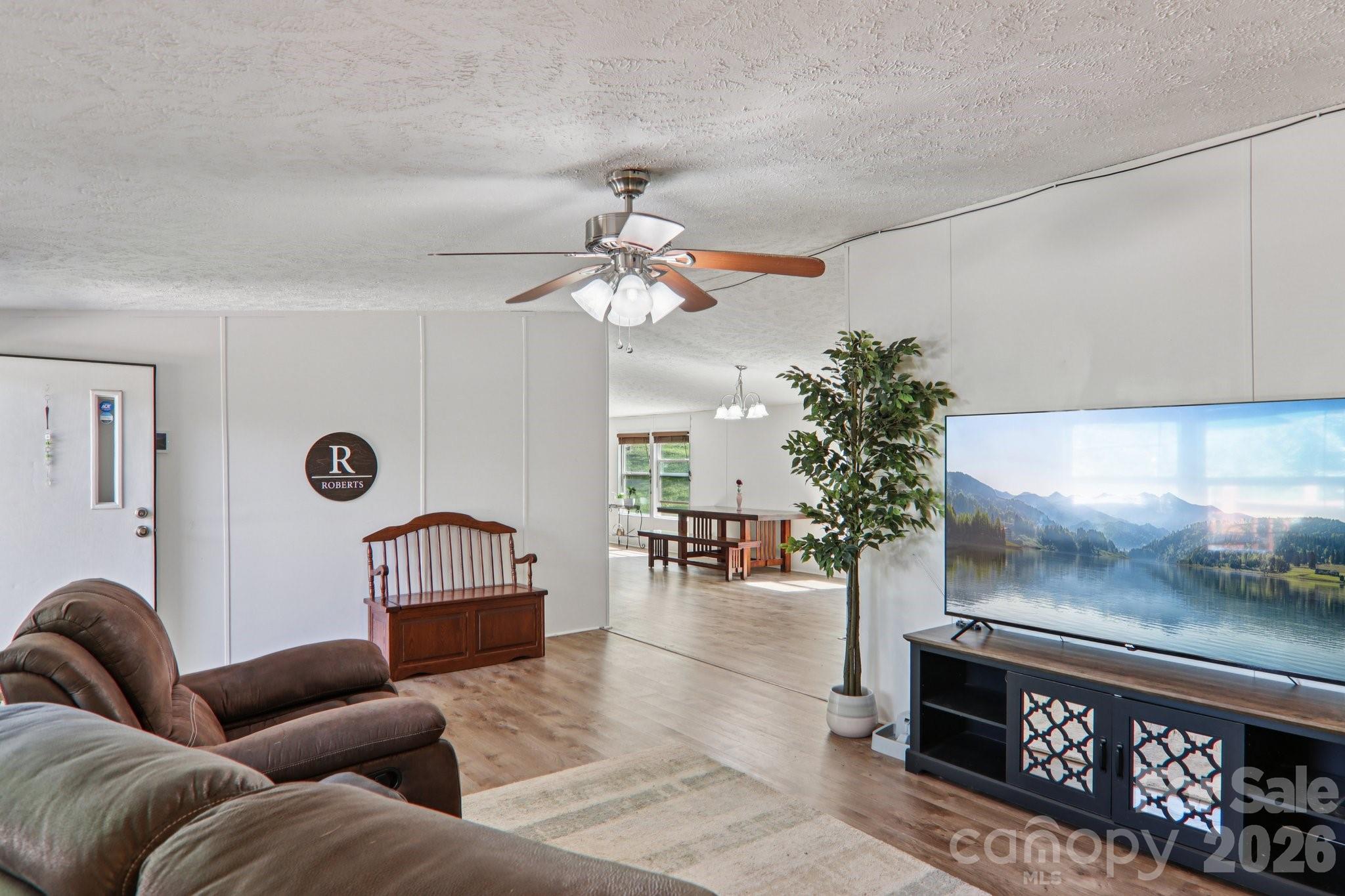 4 Sweet Birch Drive Alexander, NC 28701 - Photo 17 of 48 a living room with furniture a fireplace and a chandelier