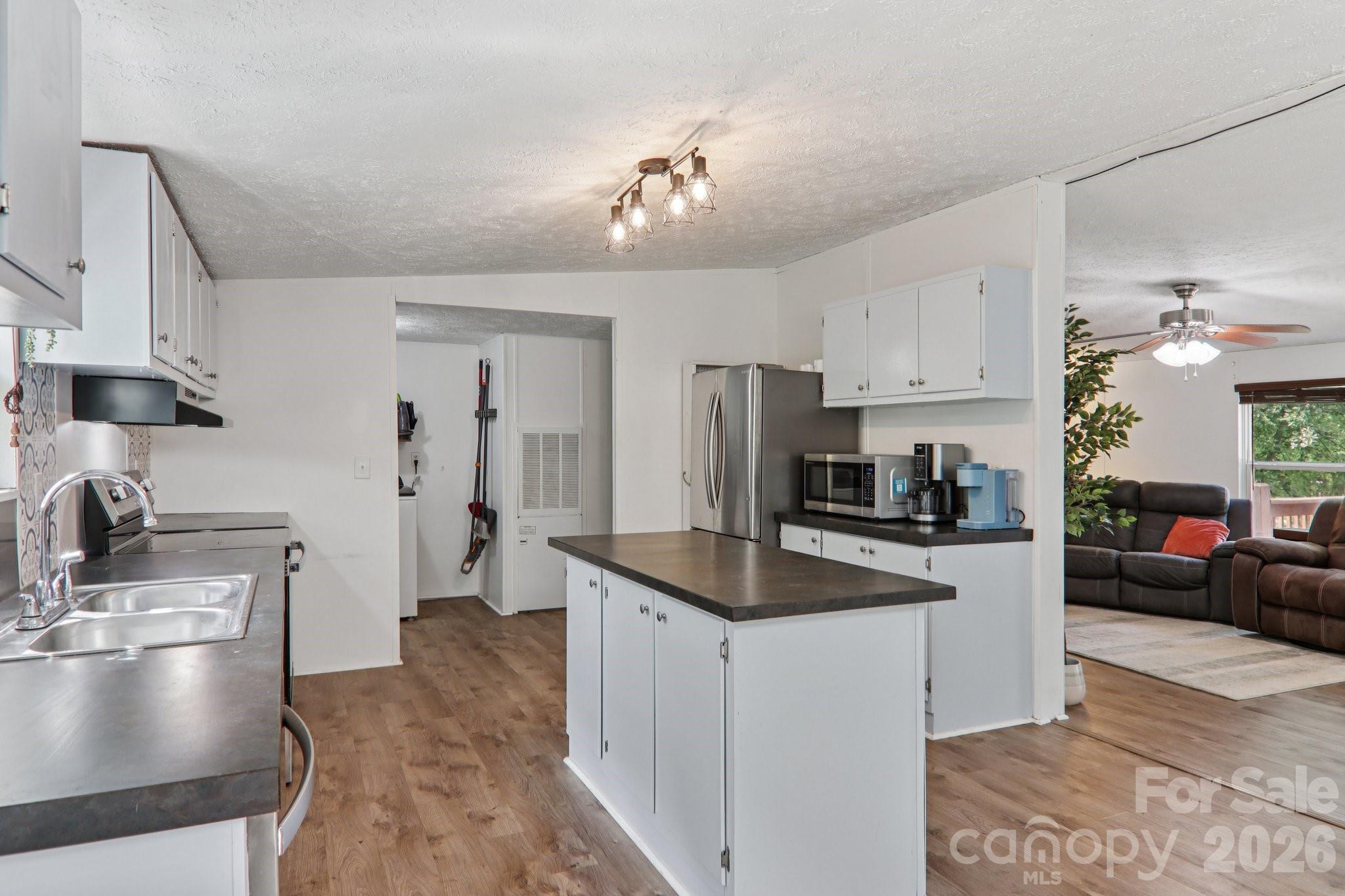 4 Sweet Birch Drive Alexander, NC 28701 - Photo 21 of 48 a kitchen with stainless steel appliances granite countertop a sink refrigerator and cabinets